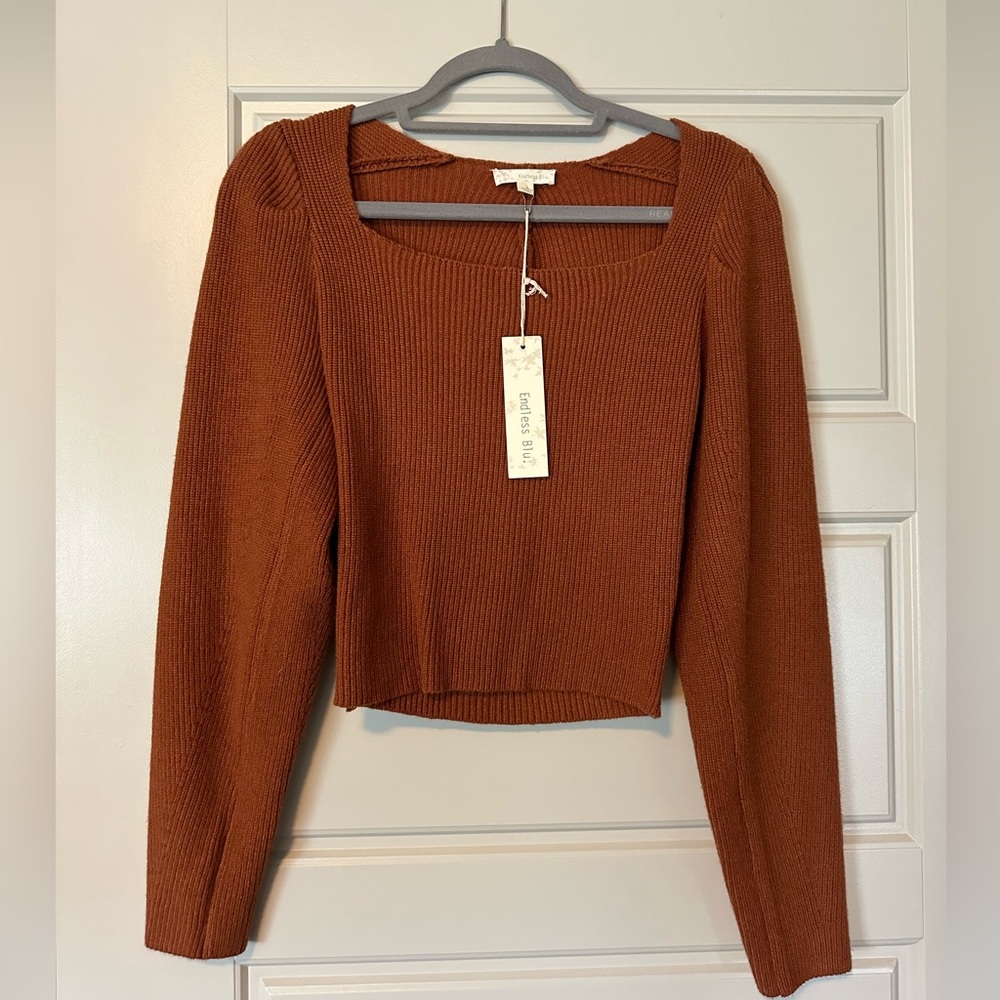 Brown women’s sweater with detailed back